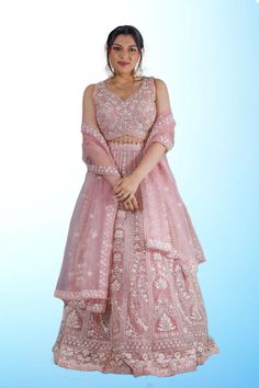 "Step into the spotlight with our exquisite collection of baby pink designer lehengas, perfect for those special occasions. Each piece is meticulously crafted to showcase all-over intricate work, ensuring that you stand out with elegance and grace.  Whether you're attending a wedding, a festive celebration, or a glamorous event, these lehengas promise to make you the center of attention, exuding beauty and grace with every wear." Party Wear Sets With Chikankari Embroidery For Reception, Pink Dori Work Sets For Eid, Wedding Anarkali Set With Chikankari Embroidery, Chikankari Embroidery Choli For Reception During Eid, Wedding Party Wear Anarkali Set With Chikankari Embroidery, Festive Pink Organza Traditional Wear, Pink Chikankari Embroidery Fabric For Reception, Diwali Party Wear Sets With Chikankari Embroidery, Pink Chikankari Embroidered Fabric For Reception