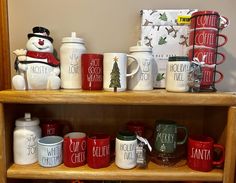 christmas mugs are sitting on top of a shelf