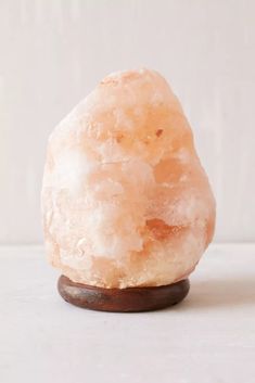 a rock sitting on top of a wooden stand