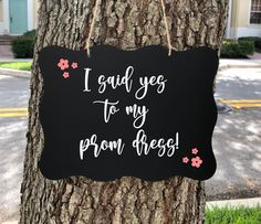 a sign that says i said yes to my bacon dress hanging on the side of a tree