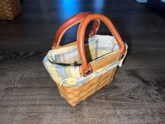 an empty basket sitting on top of a wooden floor