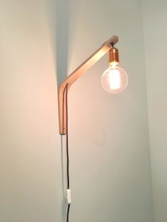 a light that is on the side of a wall with a cord attached to it