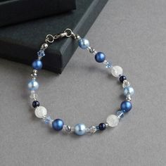 This royal blue pearl and crystal bracelet is created using glass pearls, crystals and glass beads. When the bracelet catches the light, the light dances over the facets of the crystals. Each mid blue beaded bracelet measures 7.25inches/18cm in length and is finished with a gunmetal-plated lobster clasp. To allow you to adjust your single strand bracelet to fit, I have added a 1 inch extender chain.  Your cobalt blue jewellery will arrive carefully gift wrapped in the black box pictured. ------- Blue Round Beads Bracelet For Wedding, Blue Round Bead Bracelets For Weddings, Blue Beaded Bracelets For Weddings, Blue Pearl Bracelets For Jewelry Making, Adjustable Blue Pearl Bracelet For Wedding, Elegant Blue Crystal Beaded Bracelets, Royal Blue Jewelry, Blue Bead Bracelet, Chunky Stone Necklace