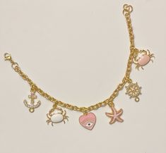 Pink Sea- Beach Inspired Charm Bracelet  6 charms  Gold plated chain Cheap Pink Charm Bracelet With Lobster Clasp, Pink Sea, Sea Inspired, Clasp Bracelet, Sea Beach, Beach Inspired, Bracelet Clasps, Gold Plated Chains, Charm Bracelets