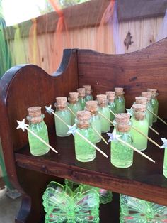 there are many green glass bottles with toothpicks in them on the wooden shelf