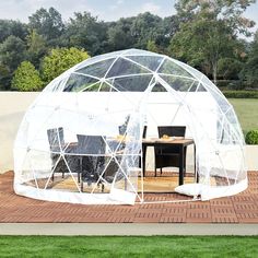 a large white dome tent sitting on top of a brick patio next to a table and chairs