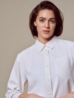 Chic White Blouse With Roll-up Sleeves, Classic White Blouse With Roll-up Sleeves, White Long Sleeve Blouse With Hidden Button Closure, Classic Blouse With Relaxed Fit For Workwear, Classic Blouse For Workwear With Relaxed Fit, Classic Relaxed Fit Blouse For Business Casual, Elegant Everyday Blouse With Shirttail Hem, Timeless White Button-up Blouse, Versatile White Blouse With Button Closure