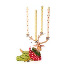 a christmas ornament hanging from a string with candles in the shape of deer heads