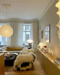 a living room filled with furniture and lamps