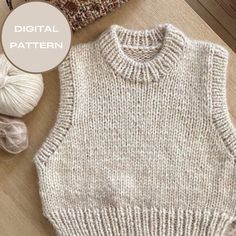 a knitted sweater and ball of yarn on a wooden floor with the text digital pattern