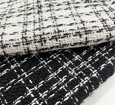 two pieces of black and white fabric on top of each other, one is woven