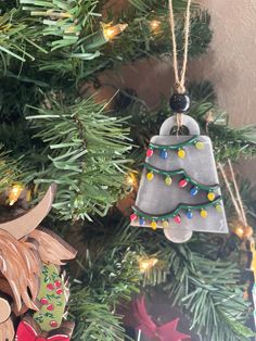 two christmas ornaments hanging from a tree