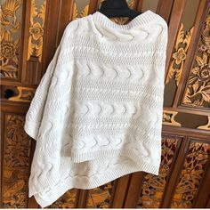 Thick Cable Knit Poncho. Can Be Worn Several Ways. Never Worn Casual White Knit Poncho, White One Size Acrylic Sweater, Beige Knit Poncho One Size, Beige Knit Poncho, One-size Beige Knit Poncho, Casual Knitted Spring Poncho, Casual Knitted Poncho For Spring, Casual Open Knit Poncho One Size, Casual Winter Open Knit Poncho