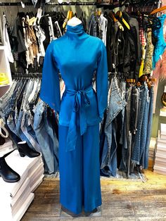 ♥ D E S C R I P T I O N ♥ Vintage 70s 2pc set. Fabric is a beautiful vibrant blue satin. Top is a tunic shape with handkerchiefs style sleeves, draped mock neck collar, and matching tie at the waist. Matching wide leg flare pants.  ♥ S I Z E & M E A S U R E M E N T S ♥ Measurements taken across while garment laying flat and unstretched. Double measurement to get the all around. Measurements- Top- Bust: 17.5 in Waist: 16 in Length: 27 in Bottoms- Waist: 13.5 in Hips: 18.5 in Length: 43 in fits si Spring Long Sleeve Rayon Sets, Spring Evening Satin Sets, Satin Evening Sets For Spring, Satin Long Sleeve Sets For Workwear, Chic Long Sleeve Silk Sets, Chic Silk Long Sleeve Sets, Fall Evening Stretch Sets, Stretch Sets For Evening Wear In Fall, Stretch Sets For Evening In Fall