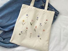 Aesthetic Wild Flowers Canvas Tote Bag, Vintage Flowers Cute Canvas Tote Bag, Gardening Aesthetic Tote Bag, Botanical Flowers Canvas Tote   This 100% cotton bag comes in one size - 15" x 16"- perfect for everyday wear. The bag features 20" handles (made from the same canvas), making it easy to carry even with a week's worth of shopping. - Liberty Bags OAD113 - ⭐ PRODUCT DETAILS ⭐ 💖 100% cotton canvas. 💖 Heavy fabric (12 oz/yd² (406.9 g/m 💖 Sewn-in label ⭐ CARE INSTRUCTIONS ⭐ 💖Machine wash: cold (max 30C or 90F) 💖Non-chlorine: bleach as needed 💖Tumble dry: medium heat 💖Do not iron directly over the printed area - print may stick to the iron. 😊If you have any questions please feel free to ask me😊 White Botanical Style Bag For Spring, Spring Botanical Rectangular Bags, Gardening Aesthetic, Liberty Bag, Flower Tote Bag, Aesthetic Tote Bag, Flowers Cute, Flowers Canvas, Canvas Making