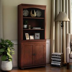 a living room with a book shelf and chair