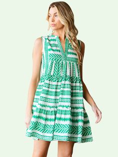 a blonde model in the green and white patterned swing dress White V-neck Tiered Dress For Summer, Summer Breezy Tiered Dress For Day Out, Breezy Tiered Summer Dress For Day Out, Multicolor Ruffled Tiered Dress For Vacation, Breezy Tiered Dress For Summer Day Out, Flowy Summer Tiered Dress For Beach, Multicolor Tiered Dress With Ruffles For Vacation, Breezy Flowy Tiered Dress For Vacation, Casual Tiered Dress For Beach