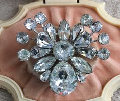 "You will receive this stunning antique Eisenberg rhinestone brooch. It is signed with the block E, which dates it between 1942-1945. It measures 2\" x 1 3/4\" and is in very good vintage condition with sparkling rhinestones and no tarnish to the metal. The safety catch is functioning properly and secure. This piece is fascinating and almost looks like a butterfly. Truly a must have for the Eisenberg collector. For finished vintage assemblage and vintage inspired jewelry, and select signed piece Vintage Crystal Brooches For Formal Occasions, Antique Rhinestones Brooch For Vintage Events, Antique Rhinestone Brooches For Vintage Events, Vintage Rhinestone Brooches For Anniversary, Vintage Brooches With Sparkling Stones For Gift, Vintage Brooches With Sparkling Stones As Gift, Vintage Crystal Brooches For Anniversary, Vintage Anniversary Brooch With Sparkling Stones, Vintage Bling Brooches For Anniversary