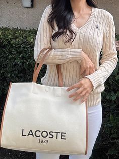 Lacoste Unisex Canvas Tote Natural Tan NU4342TD K02A tote - but a sophisticated tote. Made from an elegant canvas fabric, a nod to Lacoste's iconic tennis style. Result: A generously-proportioned bag that'll hold your essentials in style. Dimensions : L15.7 x H11.6 x D7" / L40 x H29.5 x D18 cm Cotton outer 45 cm / 18" handles 1 zipped inside pocket Large enough to fit your 17" laptop Outside : Cotton (100%) White Luxury Canvas Shopping Bag, Luxury White Canvas Shopping Bag, Casual Canvas-lined Shoulder Bag For Weekend, Casual Shoulder Bag With Canvas Lining For Weekend, Classic Beige Cotton Canvas Bag, Casual White Canvas Bag With Leather Handles, Casual Cream Shoulder Bag With Canvas Lining, Classic White Canvas Tote Bag, Preppy Bags For Daily Use