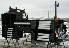 two black and white desks sitting on top of snow covered ground