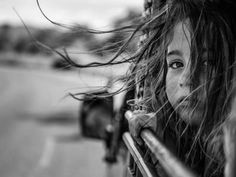 black and white photograph of a woman with her hair blowing in the wind