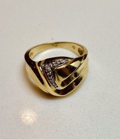 a gold ring sitting on top of a white table