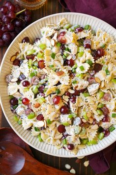 a bowl filled with pasta salad and grapes