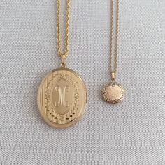 An adult-size 14K yellow gold-filled engraved floral signet oval locket on a rope chain necklace. The outer shell is solid gold pressure-bonded to an inner core of high-quality brass. Locket Dimensions: 30 mm W x 38 mm H Chain length: 22" Luxury Round Pendant Locket Necklace For Wedding, Luxury Gold Locket Necklace With Polished Finish, Cheap Locket Necklace With Round Pendant, Cheap Gold Metal Locket Necklace, Luxury Hallmarked Oval Pendant Locket Necklace, Luxury Antique Round Locket Necklace, Oval Locket Necklace, Round Locket Necklace, Round Locket