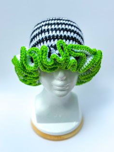 Elevate your summer style with this chic black and white striped hat, accented with a vibrant lime green lining on the brim. This eye-catching accessory is designed to keep you cool and comfortable under the sun. Features: *Stylish Design: Bold black and white stripes with a pop of lime green. *Summer-Ready: Lightweight and breathable material ensures maximum comfort. *Sun Protection: Wide brim provides excellent shade to keep the sun out of your eyes. Whether you're hitting the beach, enjoying a picnic, or just out for a sunny stroll, this hat is the perfect addition to your summer wardrobe. Stay stylish and protected all season long! Fun Green Hats For Spring, Retro Green Hat For Vacation, Trendy Green Crochet Hat For Beach, Trendy Green Crochet Hat For The Beach, Trendy Green Crochet Beach Hat, Trendy Green Brimmed Crochet Hat, Green Mini Beach Hat With Short Brim, Green Crochet Hat With Short Brim For Spring, Green Mini Hat With Short Brim For Beach