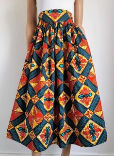 Handmade Unlined African Print Midi Skirt     Elastic waist band skirt at the back      2 open side-entry pockets     Exact length: 33"      100% Wax Cotton     Handmade     Made in the UK (Colours may vary due to lighting on images. The product images are closest to the true colour of the product.) Fitted Maxi Skirt With Side Pockets For Spring, Red Midi Skirt With Pockets, Red Midi Skirt With Elastic Waistband, Multicolor Relaxed Skirt With Elastic Waistband, Multicolor Relaxed Fit Skirt With Elastic Waistband, Multicolor Midi Skirt With Elastic Waistband, Red Full Skirt Bottoms With Pockets, Long Red Skirt With Pockets, Red Skirted Bottoms With Pockets