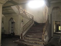 an abandoned building with stairs and lights