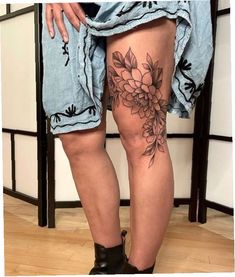 a woman's legs with flowers on them