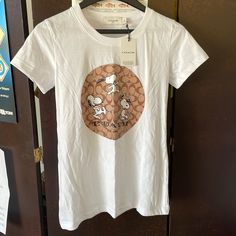 Brand New With Tags. Coach Snoopy Women’s White T-Shirt. Size Medium. It Runs A Little Small In My Opinion. Casual Cotton Coach Tops, Coach Cotton Crew Neck Tops, Casual Coach Crew Neck Tops, Coach Tshirts, Coach Shirts, White Tshirt, Black Tshirt, Snoopy, Womens Tops