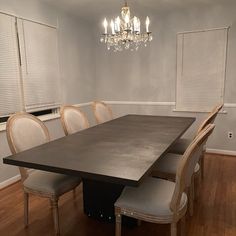 a dining room table with six chairs and a chandelier