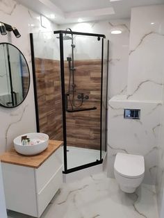 a bathroom with a toilet, sink and stand up shower in the middle of it