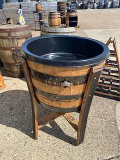 a wooden barrel sitting on top of a cement ground