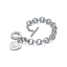 Inspired by the iconic key ring first introduced in 1969, the Return to Tiffany collection is a classic reinvented. An engraved tag and toggle closure add dimension to this timeless bracelet. Sterling silver; Heart tag, size medium; Bracelet, size medium; 8" long | Return To Tiffany® Heart Tag Toggle Bracelet in Sterling Silver, Medium Timeless Bracelet, Tiffany And Co Bracelet, Tiffany And Co Jewelry, Tiffany Bracelets, Return To Tiffany, Bracelet In Silver, Heart Tag, Jewelry Accessories Ideas, Tiffany Jewelry