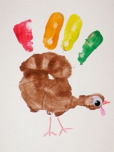 a child's hand painted with different colored crayons and the shape of a turkey