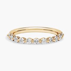 a yellow gold band with white diamonds