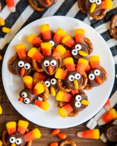 some pretzels decorated like turkeys with googly eyes and candy on them