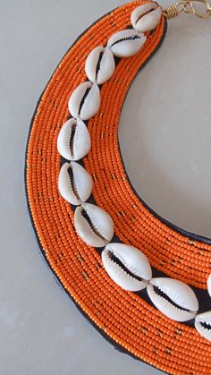 African beaded cowrie shell necklace, African ceremonial necklace, Wedding necklace, beaded necklace, Christmas gift for her This cowrie shell beaded necklace is superbly crafted which can be worn with any outfit at different occasions and it will absolutely makes you stand out. Main color -Orange. The necklace can be available in different colors. Wholesale available at a fair price,please contact me. For any clarification,please send me a convo or an e-mail. Thank you for visiting and happy sh Traditional Cowrie Shell Beaded Necklaces For Beach, Handmade Cowrie Shell Beaded Necklaces For Festivals, Traditional Shell Beaded Necklaces For The Beach, Traditional Shell Beaded Necklace For The Beach, Traditional Handmade Beaded Cowrie Shell Necklace, Traditional Beaded Shell Necklace For Festival, Traditional Orange Necklace For The Beach, Handmade Shell-shaped Beaded Necklace For Festival, Traditional Cowrie Shell Necklace For Festivals