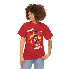 Not available in stores. Take your style to new heights with this Power in the Puffs tee. This unisex heavy cotton tee is perfect for anyone who wants to show off their superhero style. The shirt features a bold print of the iconic Afro Puff Superhero on the front, making it a must-have for any fan of Black Superheroines. Whether you're wearing it to the gym or out on the town, this tee is sure to turn heads and get you noticed. So power up and put your best foot forward in this stylish Superher Superhero Cotton Tops For Streetwear, Superhero Fan Merchandise Cotton T-shirt, Cheer Mom Shirt, Superhero Fashion, Cheer Mom Shirts, Cheer Girl, Afro Puff, Cheer Mom, Bold Prints