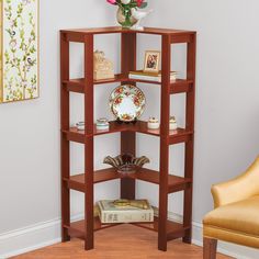 a corner shelf in the corner of a room filled with books and vases on top of it