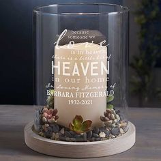 a candle that has been placed in a glass container with rocks and gravel around it