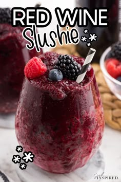 red wine slushie in a glass with raspberries and blackberries on top