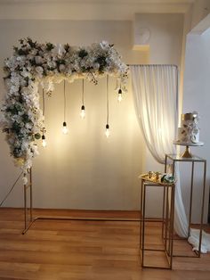 a wedding arch decorated with flowers and lights