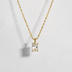 This timeless necklace is the perfect addition to elevate any look. Featuring a beautiful emerald cut diamond, this necklace will add the perfect amount of elegance to any outfit. Can be worn alone or paired with other pieces for a gorgeous stacked look! Made of 925 Sterling Silver THICK plating of 14k Gold or Rhodium Chain Length - 16” or 18" + 3” Extension Made of HIGHEST QUALITY Cubic Zirconia VERY HIGH QUALITY Nickel-free & Hypoallergenic - will not irritate skin! Lobster Clasp Closure Classic Formal Necklace With Rectangular Pendant, Classic Formal Necklaces With Rectangular Pendant, Classic Necklace With Adjustable Chain And Rectangular Pendant, Classic Necklaces With Adjustable Chain And Rectangular Pendant, Elegant Jewelry With Square Pendant And Adjustable Chain, Elegant Square Pendant Jewelry With Adjustable Chain, Timeless Gold Solitaire Necklace With Emerald Cut, Dainty Gold Baguette Cut Necklace, Timeless Emerald Cut Diamond Necklace Gift