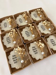 six wedding favors in a box with flowers and pearls