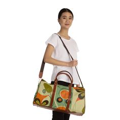 Jet set in psychedelic style with this retro 1960s inspired daisy duffel bag. Featuring a bold floral print in mod colors, this groovy weekender carry-on pops with flower power vibes. Expertly crafted from high grade materials with leather accents, this 20" × 12'' × 9" overnight bag is ideal for quick trips and weekend getaways. The vibrant daisy pattern and geometric details give this hip bag far out old school flair. Pack in peace and travel back to the age of free love with this funky floral Retro Green Shoulder Bag With Large Capacity, Retro Green Everyday Bag, Green Retro Everyday Bag, Retro Green Satchel Shoulder Bag, Retro Satchel For Everyday Use With Large Capacity, Retro Large Capacity Satchel For Everyday Use, Retro Large Capacity Satchel For Daily Use, Large Capacity Retro Satchel For Daily Use, Retro Green Tote Bag