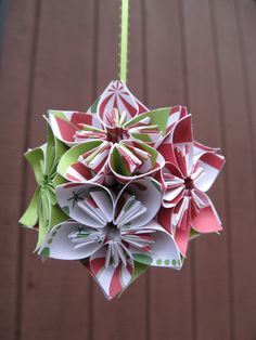 an origami flower hanging from a string